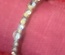 Silver ring, adjustable size, with heart shaped white crystals at both ends.