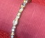 Silver ring, adjustable size, with heart shaped white crystals at both ends.
