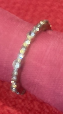 Silver ring, adjustable size, with heart shaped white crystals at both ends.